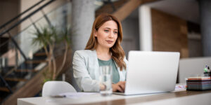 Successful businesswoman using laptop, working in office. Business technology corporate concept