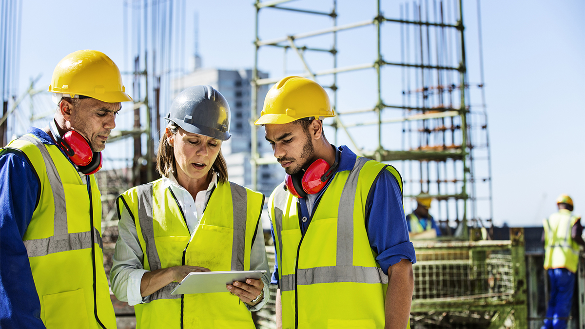 Architects using digital tablet at site